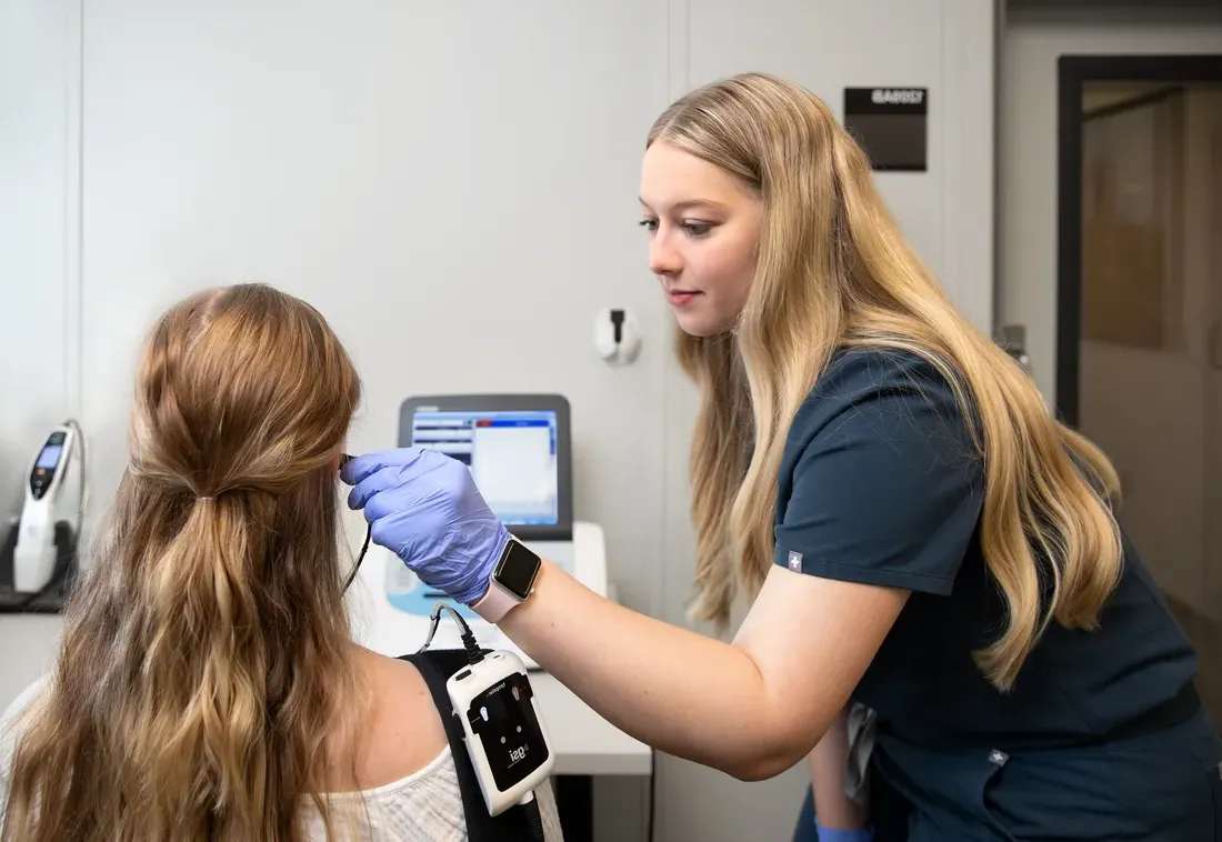 Student checking patients ears at the Gebbie Clinic.